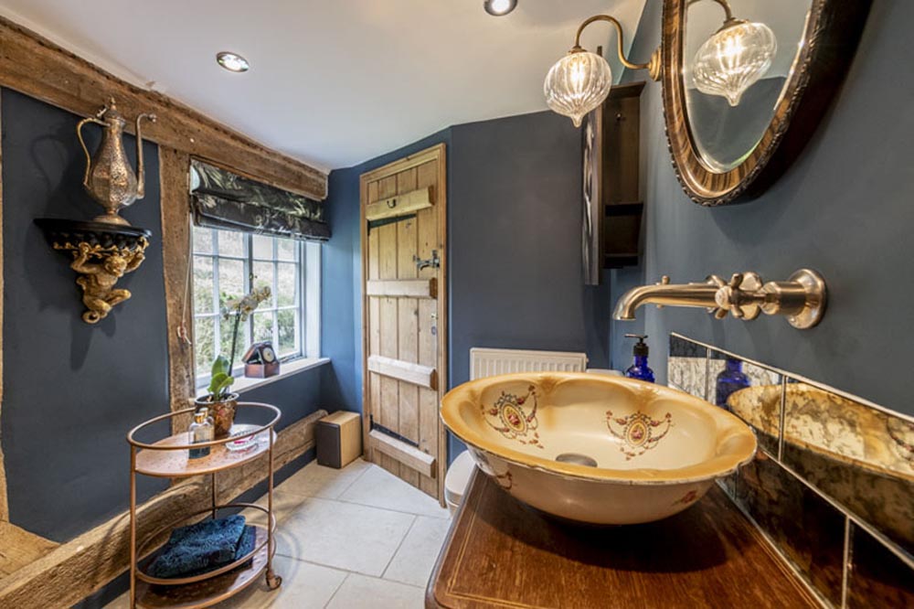A characterful, unique bathroom in a historic cottage with many wooden fittings