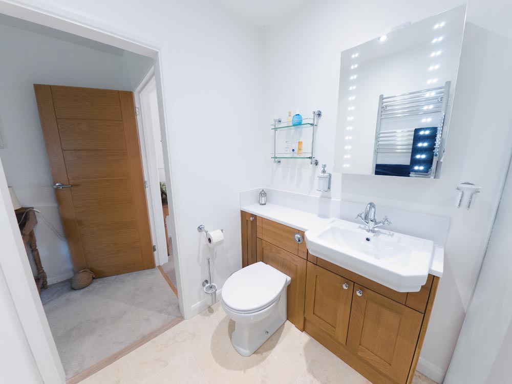 pine fitted furniture in a white bathroom